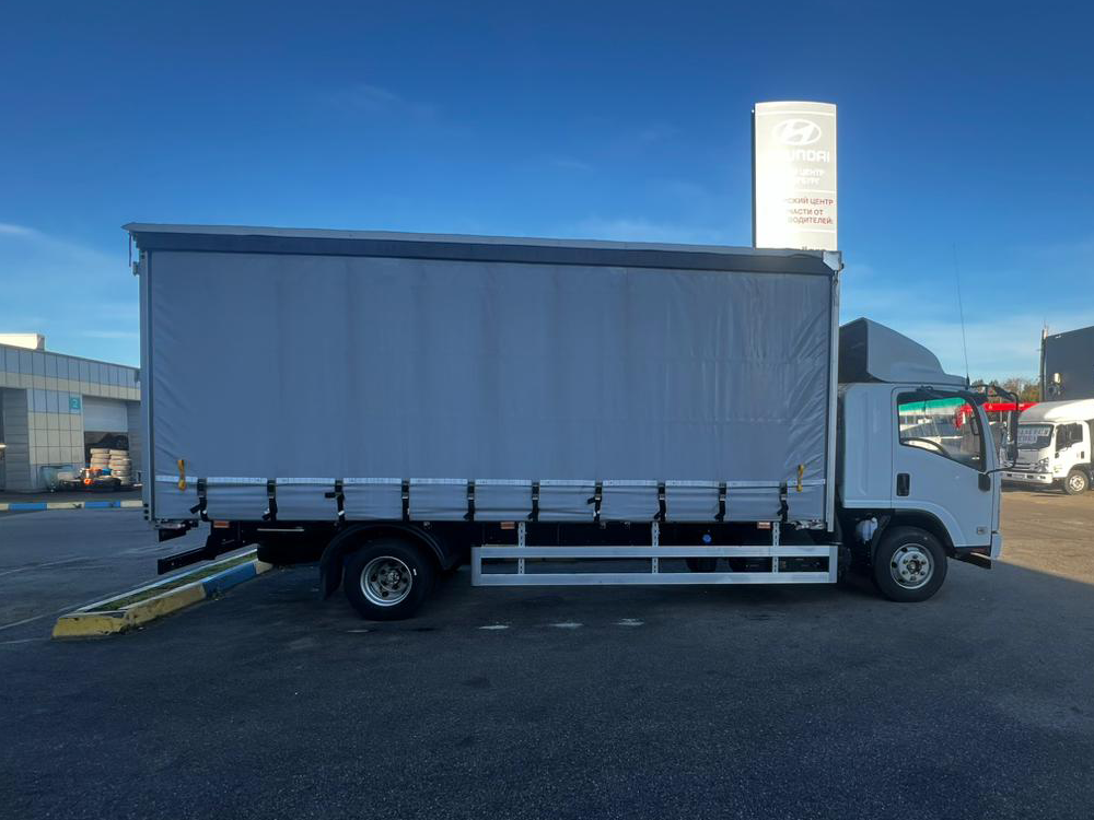 Бортовой грузовик ISUZU тентованный 5,5 т.,6,2 м фото 4